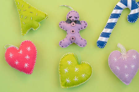 Christmas, top view handmade Christmas ornaments or decorations isolated on green surface. New year or christmas greeting on neon green backgroundの写真素材