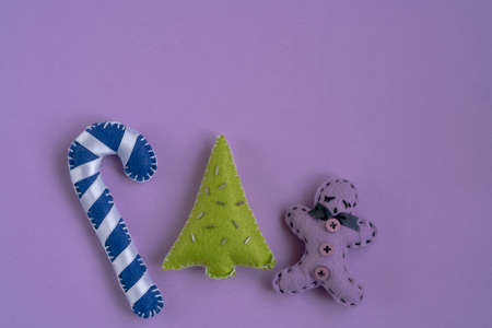 noel, top view handmade Christmas ornaments isolated on purple surface with copy space. New year or christmas greeting on purple backgroundの写真素材