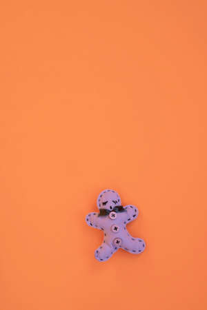 Christmas card, top view Gingerbread man cookie shaped Christmas ornament isolated on neon orange...