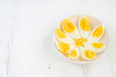 eggs, sliced boiled eggs on white plate on wooden background or table for a healthy breakfast....
