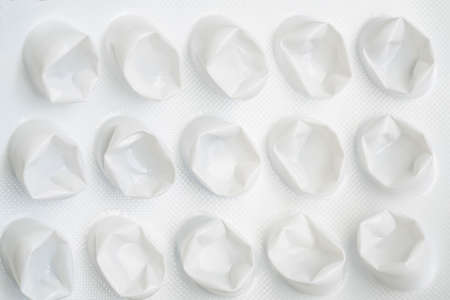 pill pack, white used empty pill or medicine foil or blister pack on gray background. pharmacy...