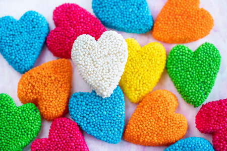candy, top view of colorful heart shaped jelly candies as a background for valentines day. sweet food concept background or surface with multicolored heart shaped jelly sugars with selective focusの写真素材
