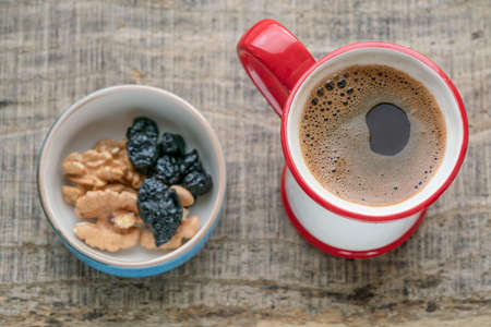 coffee, top view of cup of turkish coffee and dried fruits on wooden table or background or surface....