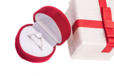 ring, diamond engagement or wedding ring in a heart shaped red box isolated on white background....