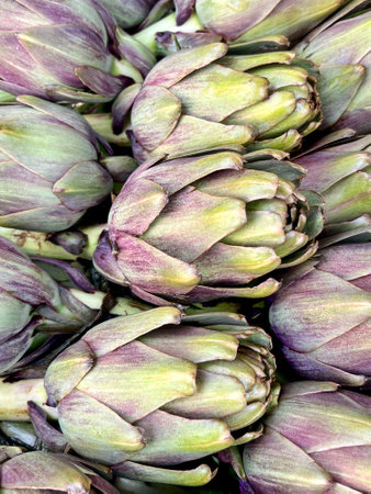 artichokes, heap or pile of fresh raw artichokes in a farmer market. fresh food concept with beautiful raw vegetablesの写真素材