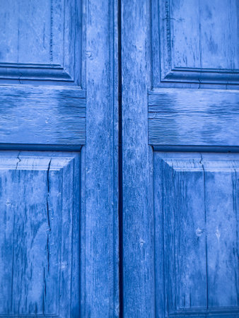 door, blue colored old wooden door. cracked wooden background or surface. entrance of an old village house in Mediterranean countries, turkey, Greece or Italy. blue surface or textured backgroundの写真素材
