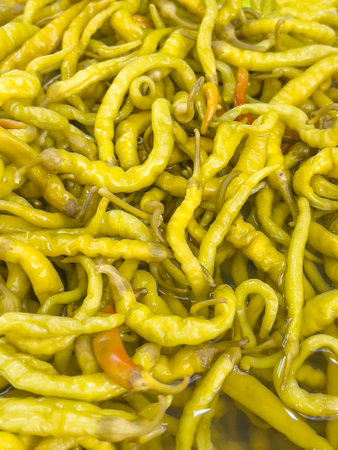 pickles, top view delicious pickled yellow green hot peppers as a background or surface. traditional turkish side food concept background. healthy marinated or pickled vegetables. pickled peppersの写真素材