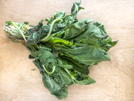 rotten, top view bunch of rotten mould arugula salad leaves on wooden background or surface. healthy...