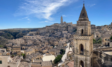 Italy, Tower over famous Matera town of Italy selected historical heritage center. Travel destinations concept photo with historical tower with selective focus, buildings in Puglia regionの写真素材