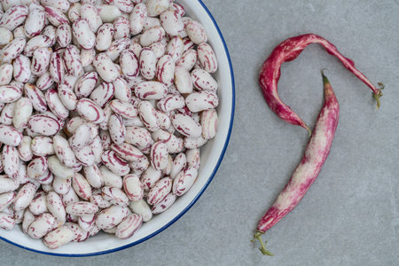 kidney beans, top view raw red kidney beans on gray with copy space. raw fresh summer vegetables on...