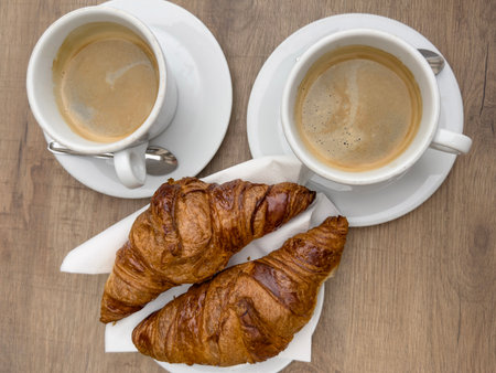 coffee, top view cups of americano coffee and delicious French Croissants on table in morning. Traditional tasty breakfast in France. French food concept. Bakery and coffee on table. cafe in Franceの写真素材