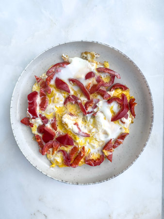food, Scrambled eggs with red bell pepper on plate, closeup top view delicious homemade breakfast,...