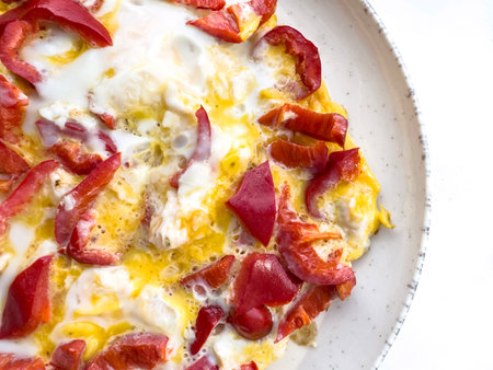 food, Scrambled eggs with red bell pepper on plate, closeup simple homemade breakfast, healthy...