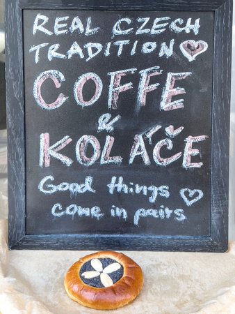 bakery, Handwritten chalkboard sign promoting traditional Czech coffee and kolace pastry, cozy local bakery atmosphere in Prague, Czechia, authentic European cafÃ©. traditional Czech food in Pragueの写真素材