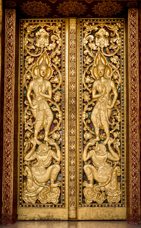 door made of wood and carved with the delicate and beautiful.の写真素材
