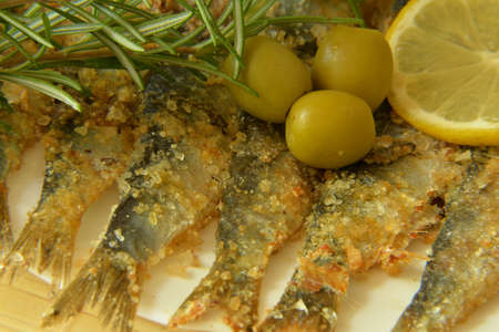 Salted anchovy with lemon, rosemary and olivesの写真素材