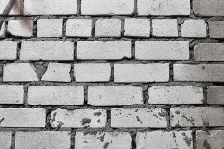Old grunge red brick wall texture or background, closeup.