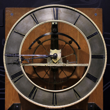 Old vintage antique clock on black background.
