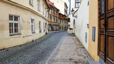 View on the narrow cobblestoned street in Prague, Czech Republic.の写真素材