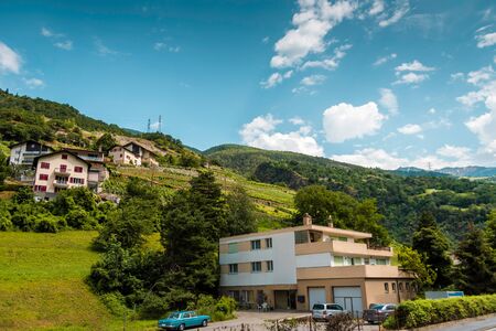 View of the houses and the hillside garden on summer dayの写真素材