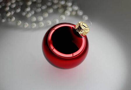 Red christmas ball and beads over white background, isolated.の写真素材
