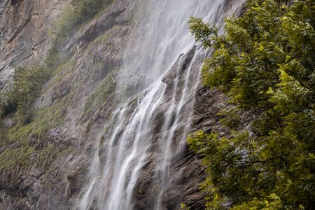 Small mountain waterfall. Summer alpine mountain landscapeの写真素材