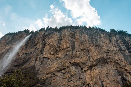 Small mountain waterfall. Summer alpine mountain landscapeの写真素材