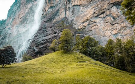 Small mountain waterfall. Summer alpine mountain landscape. Famous valley of waterfalls in Lauterbrunnen.の写真素材