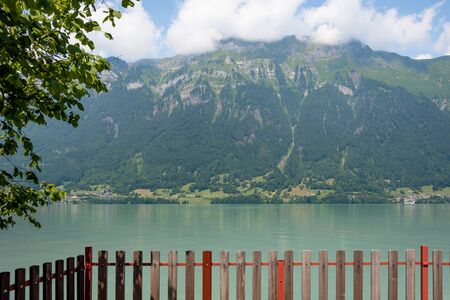View of lake with clear turquoise water. Light haze on a hot summer day.の写真素材