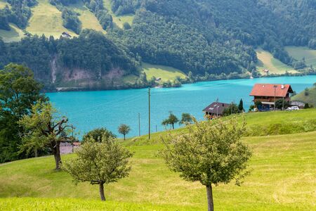 Stunning turquoise Lake Lungerersee with clear water, canton of Obwalden, Switzerland. Incredibly bewitching and calm placeの写真素材