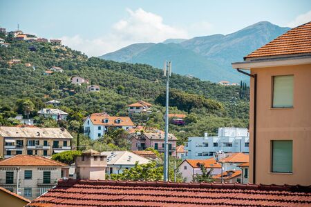 Top view of a street with low houses with red tiles. green Street. hill view.の写真素材