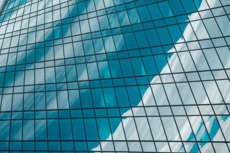 The sky is reflected in the Skyscraper windows, urban city architecture.の写真素材