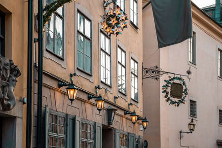 Narrow streets with New Years, Christmas decorations, festive garlands and stars on the facades of old houses on the streets in Gamla Stan, Stockholm, Sweden, January 2020の写真素材