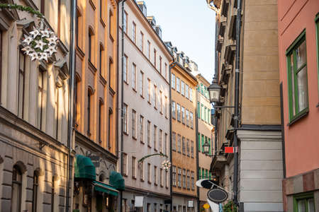 Narrow streets with New Years, Christmas decorations, festive garlands and stars on the facades of old houses on the streets in Gamla Stan, Stockholm, Sweden, January 2020の写真素材