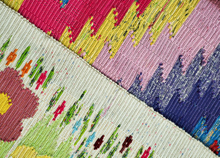 An old floor mat made on a loom. Folk craft, colorful threads, texture or backgroundの写真素材
