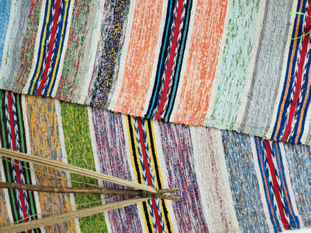 An old floor mat made on a loom. Folk craft, colorful threads, texture or backgroundの写真素材