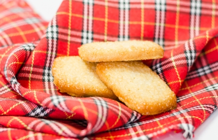 Three sugar cookies on red tartan dishtowelの写真素材