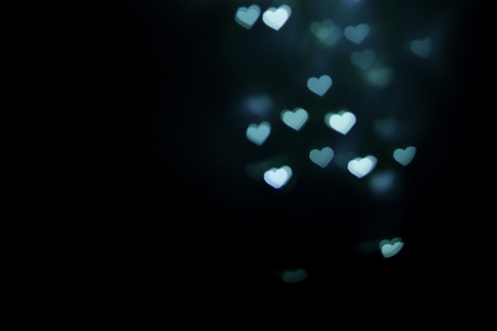Blurred blue heart shape bokeh backgroundの写真素材