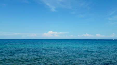 blue ocean calm waves and blue sky on a summer dayの写真素材