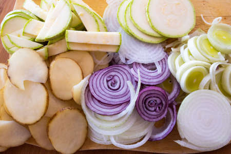 sliced vegetables, cut vegetables on wooden background. Veggies cooking ingredients, top view, copy spaceの写真素材