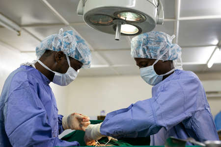 Makeni, Sierra Leone - June 22, 2019: African doctors surgeons operating on a patient in hospitalのeditorial素材