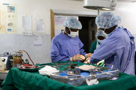 Makeni, Sierra Leone - June 22, 2019: doctors surgeons operating on a patient in an african...