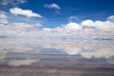 Salar de Uyuni. Perfect sky and clouds reflection on the water of the salt flatの写真素材