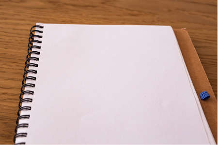 blank notebook for writing concepts on a wooden background. Copy space