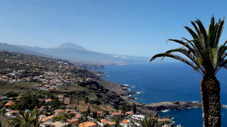 beautiful Tenerife north coast with the Teide volcano on the background. Panoramic view of Tenerife turistic north coast with villages on cliffs and plantationsの写真素材