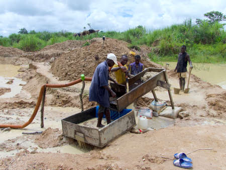 Kono District, Sierra Leone - 1st July 2019: group of men washing the soil and working the land in search of diamonds in the artisanal mines of Sierra Leoneのeditorial素材