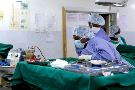 Makeni, Sierra Leone - June 22nd, 2019: African surgeons operating on a patient in a hospitalのeditorial素材