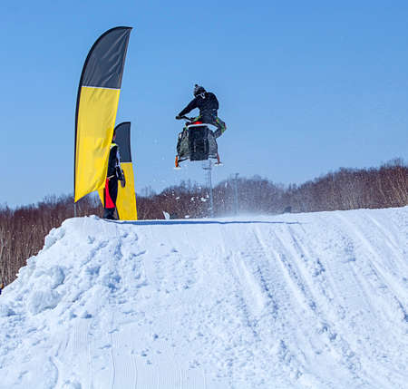 Snowmobile on the route in a jump in air in Kamchatkaの写真素材