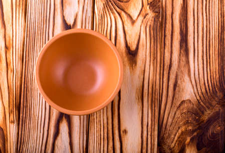 smooth empty brown cup on a wooden table
