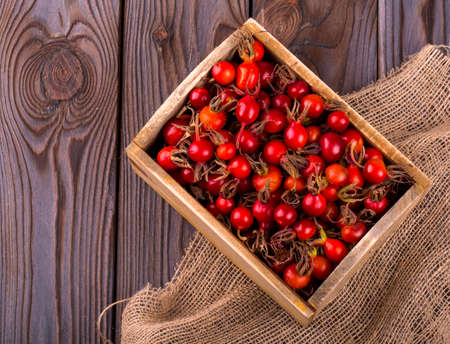 ripe briar in wooden box and sacking on wooden table on wooden backgroundの写真素材
